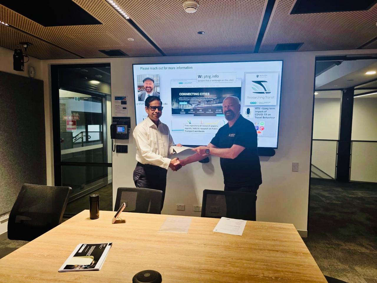 MoU handshake at Monash Public Transport Research Group